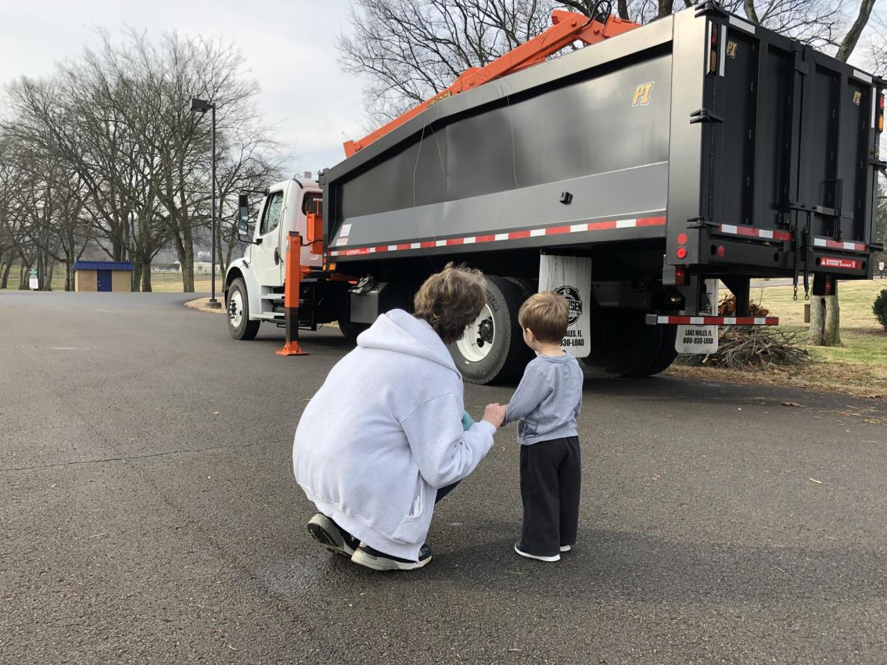 image of a woman and child looking at a truck