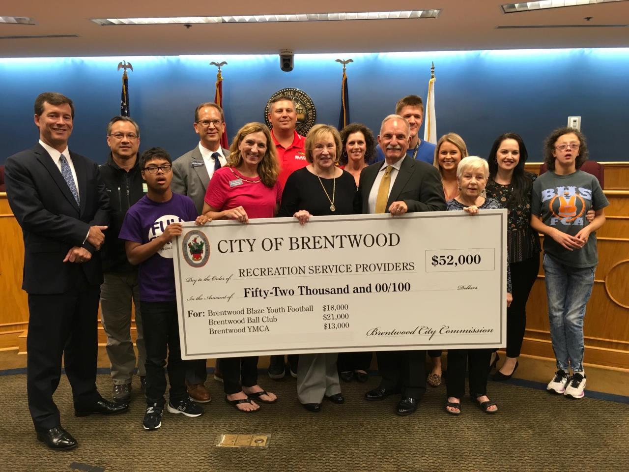 people standing with large check presentation
