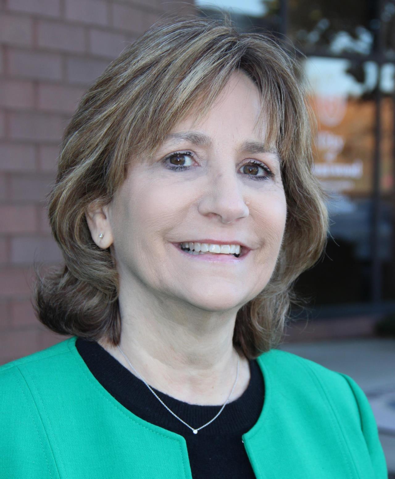 photo of Karen Harper wearing green jacket outside
