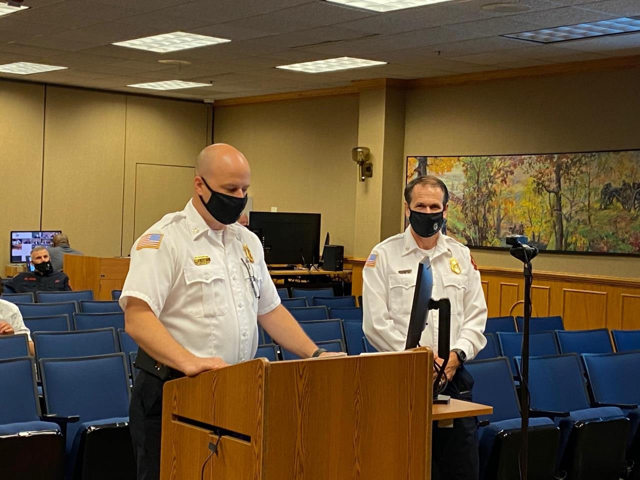 Battalion Chief David Harber, two men standing beside each other at a podium