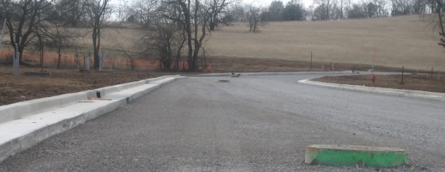 picture of a street in the first stage of development with rough pavement
