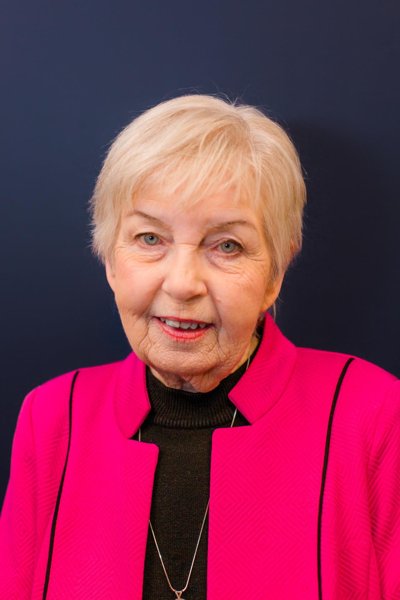 photo of woman in pink suit