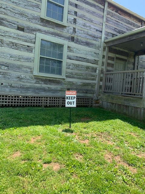 log cabin with do not enter sign