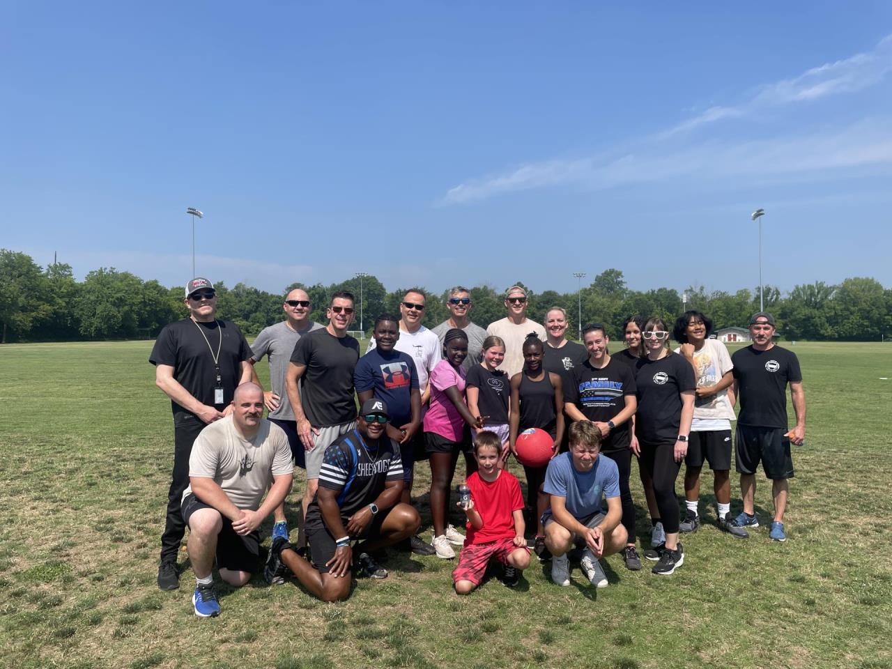 Photo of PD members with kids at Kickball Event