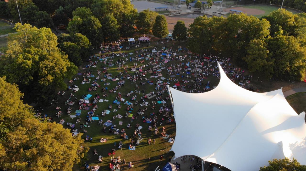Aerial view of the crowd and side of the amphitheater as the sun goes down.